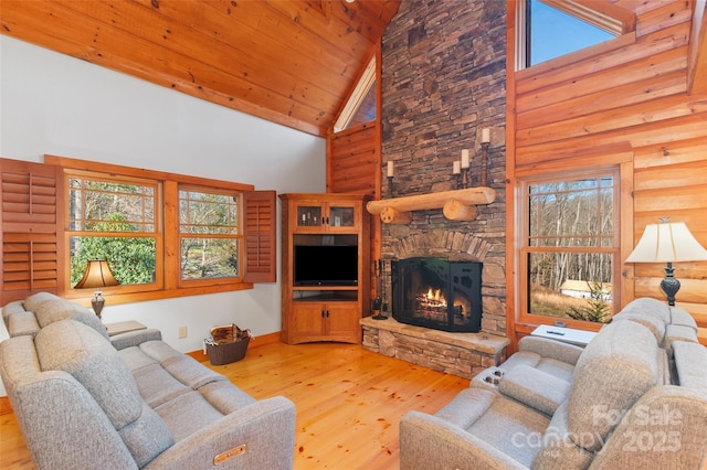 living room featuring rustic walls, high vaulted ceiling, a fireplace, light hardwood / wood-style floors, and wooden ceiling