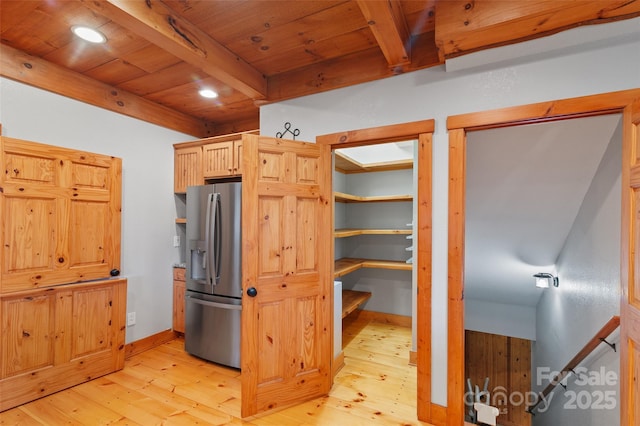 kitchen featuring wooden ceiling, light wood-type flooring, light brown cabinets, stainless steel fridge, and beamed ceiling