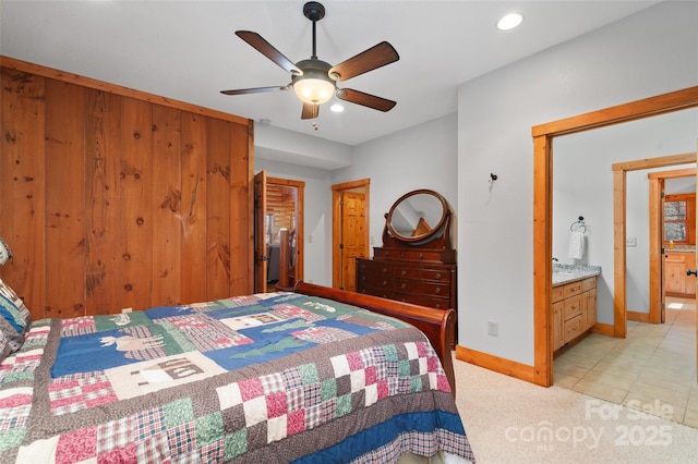 bedroom with light carpet, ceiling fan, and ensuite bathroom