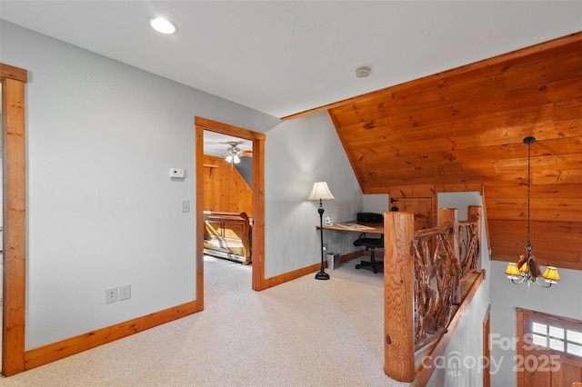 carpeted office with lofted ceiling and a chandelier