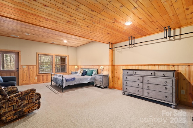 bedroom with multiple windows, wood ceiling, and light colored carpet