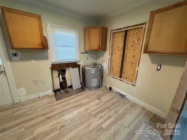 laundry area with light hardwood / wood-style flooring, crown molding, and water heater