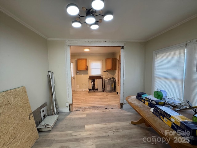 dining room with ornamental molding, a notable chandelier, and light wood-type flooring