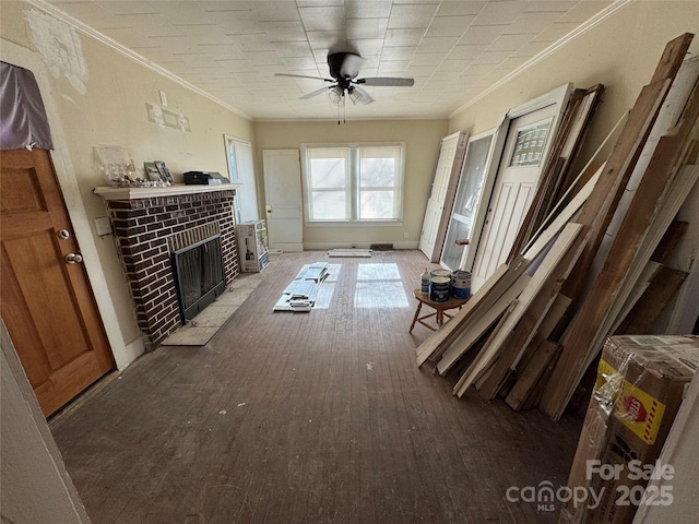 interior space featuring ceiling fan, ornamental molding, a fireplace, and hardwood / wood-style floors