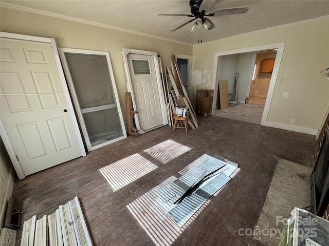 unfurnished living room with ceiling fan, ornamental molding, and dark hardwood / wood-style floors