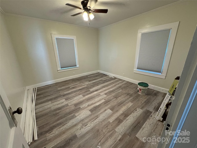 unfurnished room with ceiling fan, crown molding, and wood-type flooring