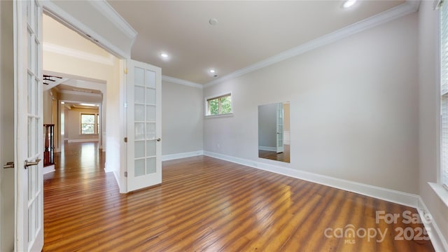 spare room featuring ornamental molding, dark wood-type flooring, and french doors