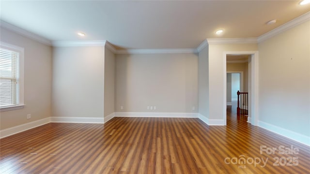 spare room with plenty of natural light, crown molding, and dark wood-type flooring