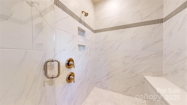 bathroom with tiled shower