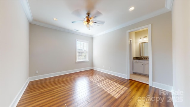 unfurnished bedroom with ensuite bathroom, ceiling fan, light hardwood / wood-style floors, and crown molding