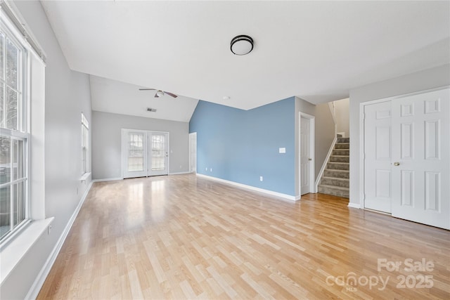 unfurnished living room featuring ceiling fan, lofted ceiling, and light hardwood / wood-style floors