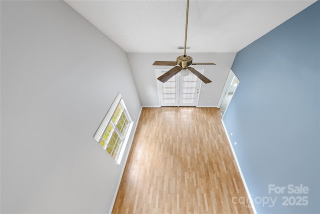 unfurnished living room with ceiling fan and light wood-type flooring