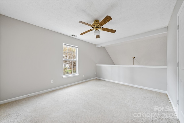 bonus room featuring lofted ceiling, light carpet, and a textured ceiling