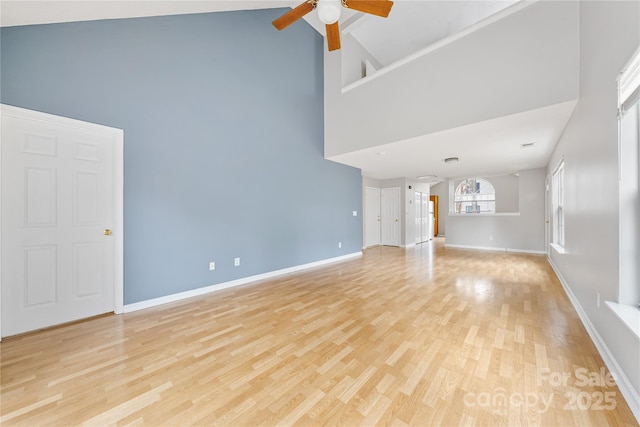 unfurnished living room with high vaulted ceiling, light hardwood / wood-style floors, and ceiling fan