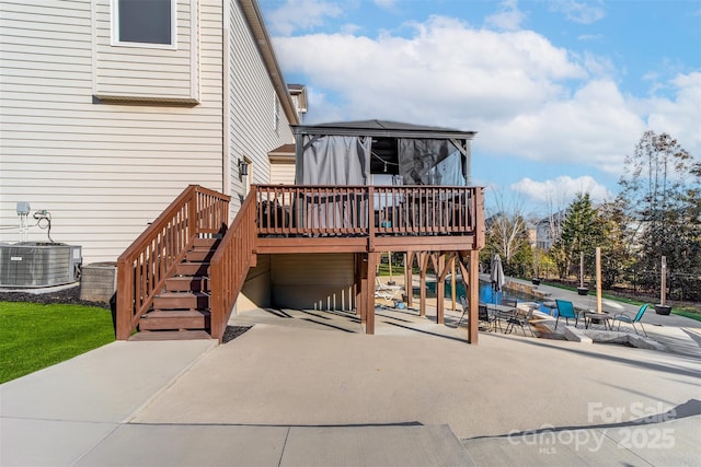 rear view of property featuring a patio area, a deck, and central air condition unit