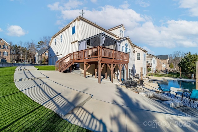 back of house with a swimming pool side deck, a yard, and a patio