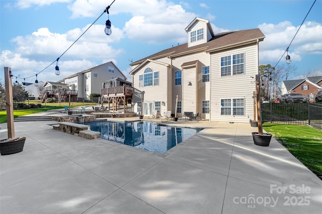 rear view of house featuring a patio area and a fenced in pool