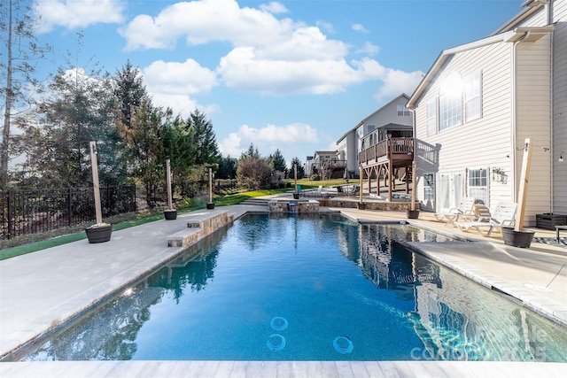 view of swimming pool featuring a deck and a patio