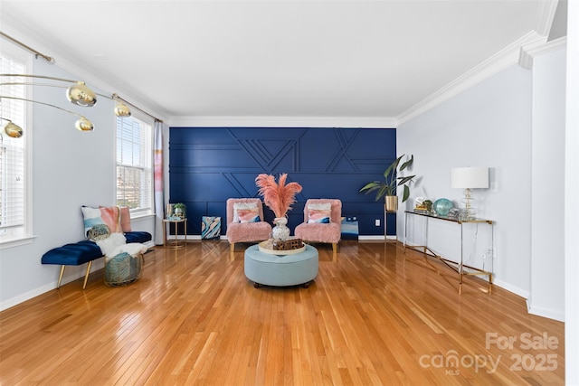 sitting room featuring hardwood / wood-style flooring and ornamental molding