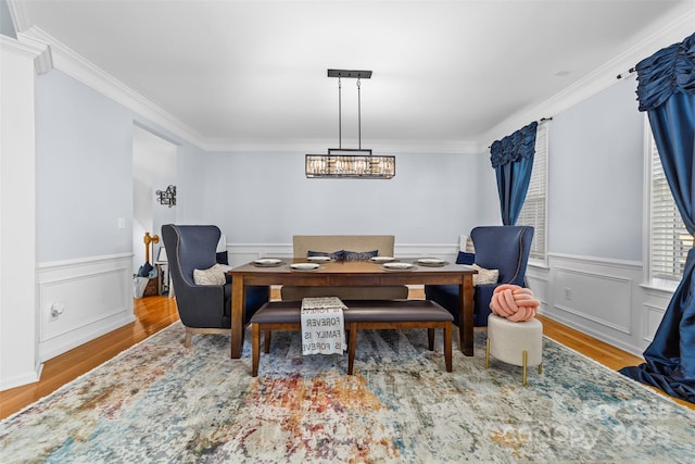 dining room with ornamental molding and wood-type flooring