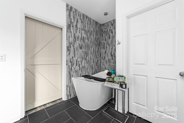 bathroom with a washtub, tile walls, and tile patterned flooring