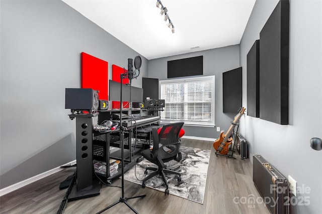 office area featuring rail lighting and hardwood / wood-style flooring