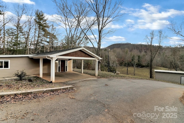 view of parking / parking lot with a carport