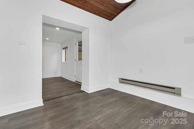 empty room featuring a baseboard radiator, vaulted ceiling, dark hardwood / wood-style floors, and wood ceiling