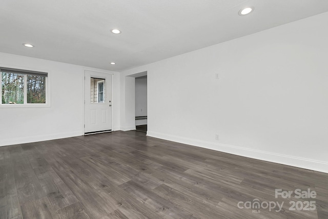 unfurnished room with dark wood-type flooring