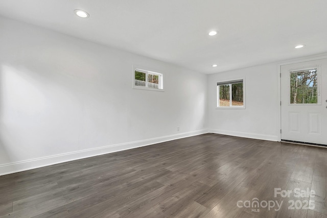 spare room with dark hardwood / wood-style flooring