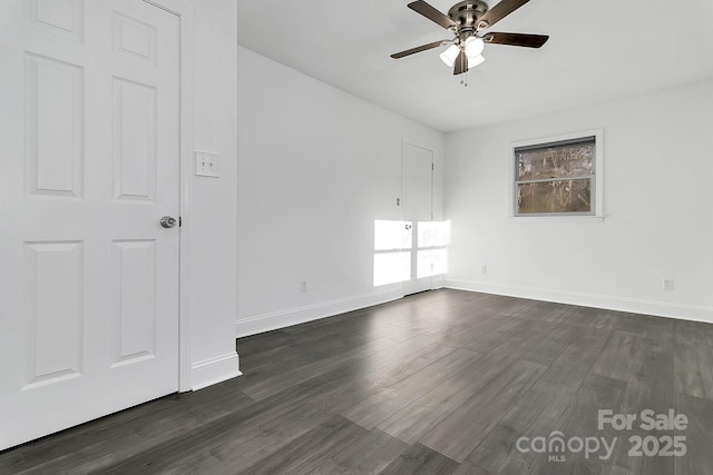 empty room with ceiling fan and dark wood-type flooring