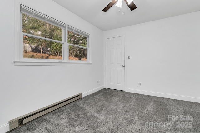 carpeted spare room with ceiling fan and a baseboard heating unit