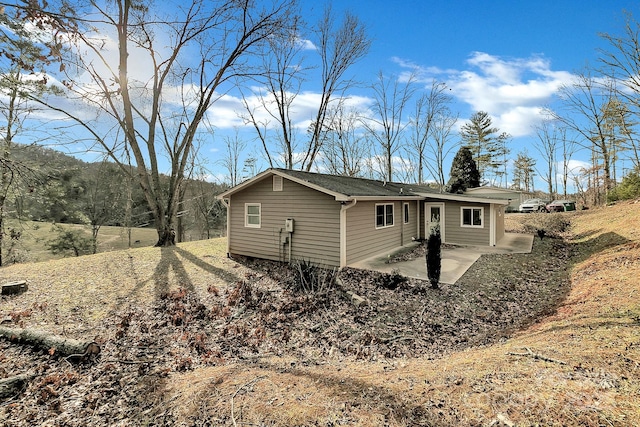 view of side of property with a patio area