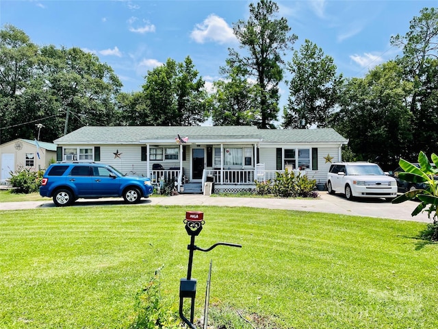 ranch-style home with covered porch and a front lawn