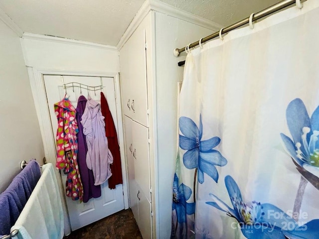 bathroom featuring walk in shower and crown molding