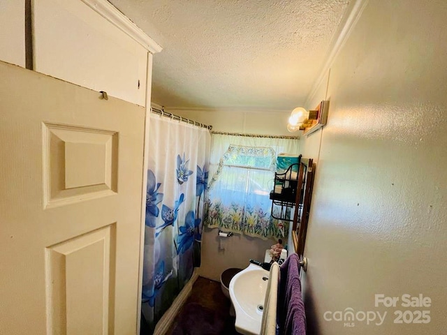 bathroom with a textured ceiling and walk in shower