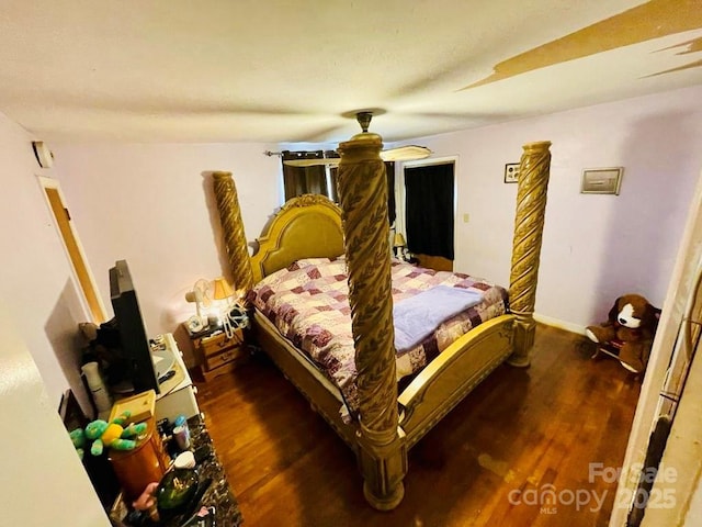 bedroom featuring ceiling fan and dark wood-type flooring