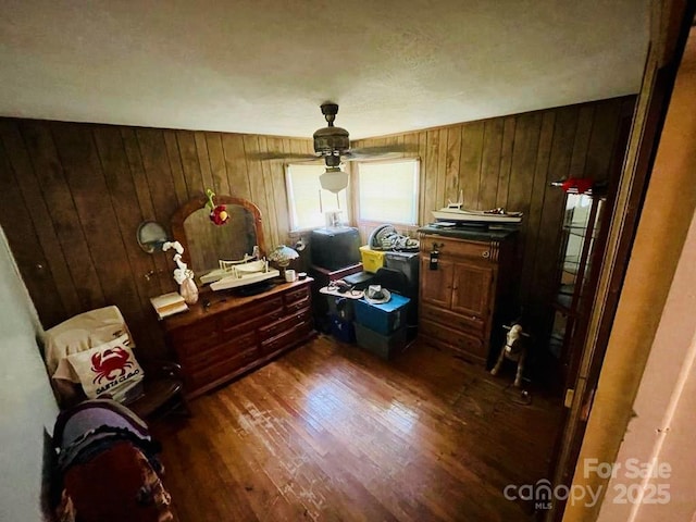 miscellaneous room featuring wood walls and dark hardwood / wood-style floors