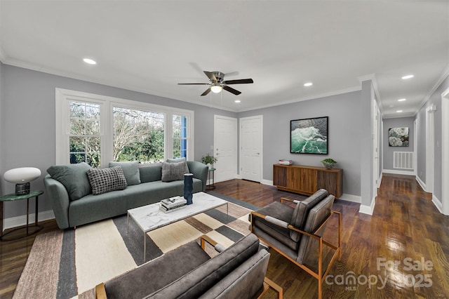 living room with crown molding, ceiling fan, and dark wood-type flooring