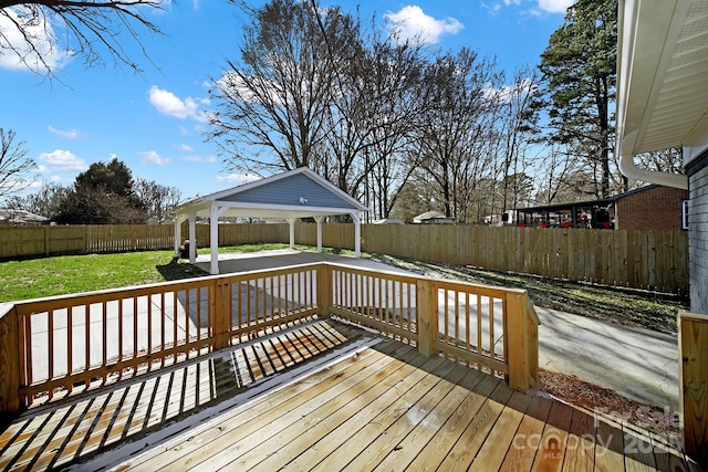 wooden terrace featuring a gazebo and a yard