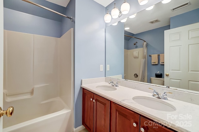 full bathroom featuring toilet, bathing tub / shower combination, and vanity