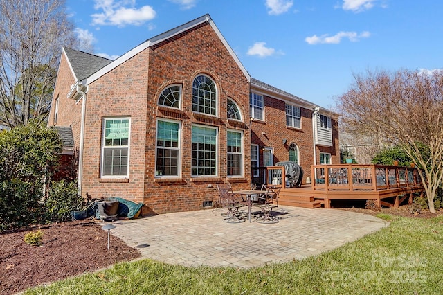 rear view of property with a deck and a patio area