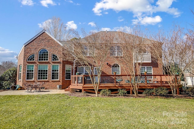 back of property with a patio, a deck, and a yard