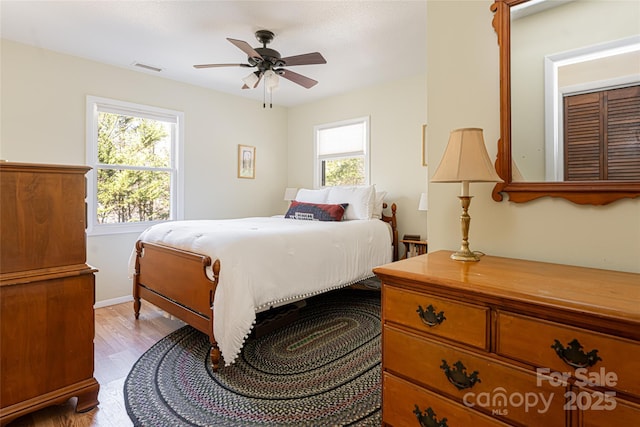 bedroom with ceiling fan and light hardwood / wood-style floors