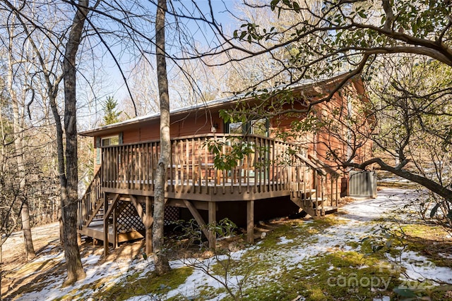 back of property featuring a deck with water view