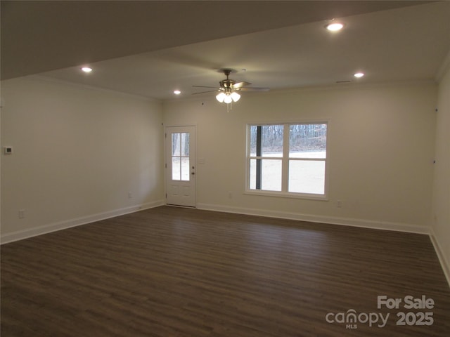 unfurnished room with dark hardwood / wood-style floors, ceiling fan, and ornamental molding