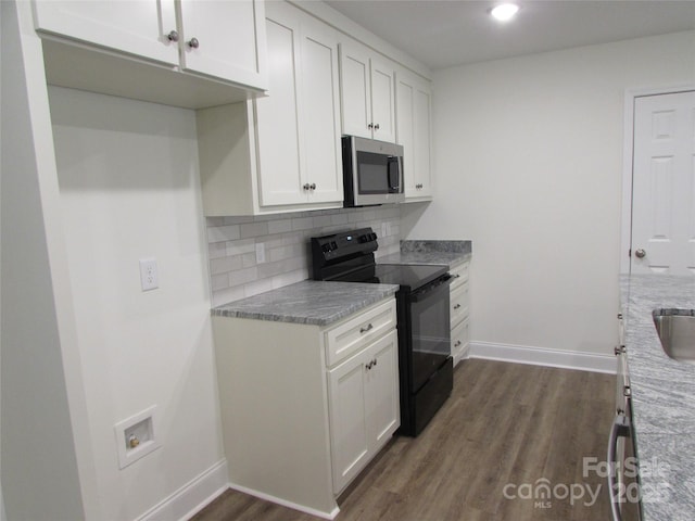 kitchen with white cabinetry, decorative backsplash, electric range, and light stone countertops