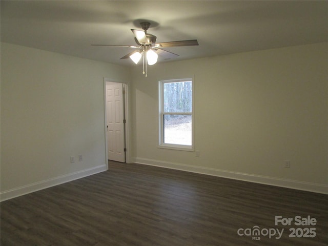 spare room with ceiling fan and dark wood-type flooring