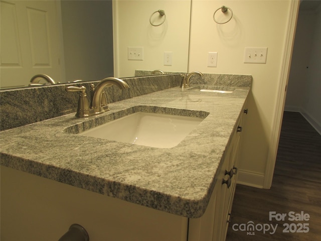 bathroom with vanity and hardwood / wood-style flooring