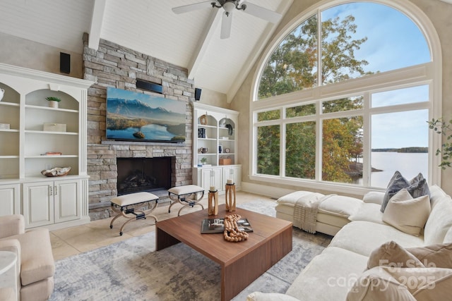 tiled living room featuring high vaulted ceiling, a stone fireplace, ceiling fan, built in features, and beam ceiling